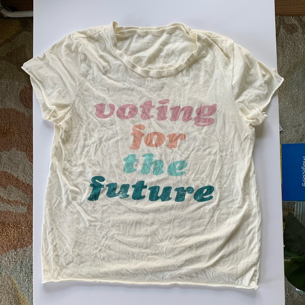 Short, airy, cream “voting for the future” top